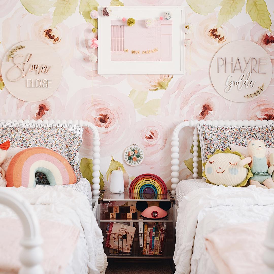 Shared girls room with pink design and rainbow themes.