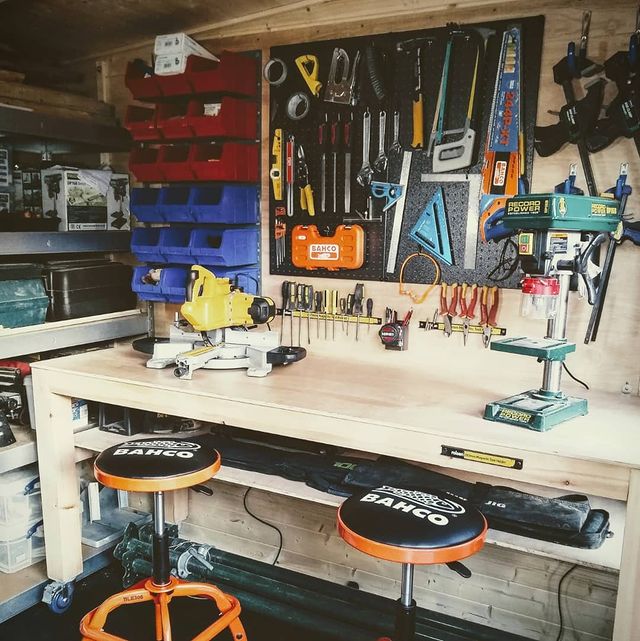 Several tools attached to a garage wall tool board using magnets. @ burwood_build