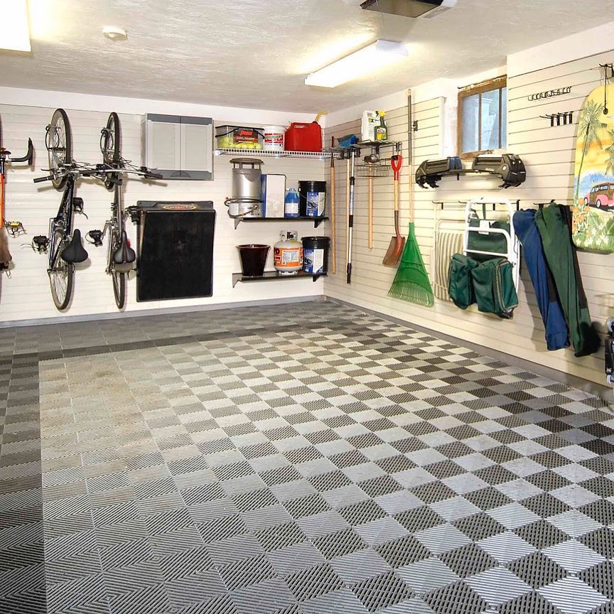 Tools organized and hung up on slat walls inside a garage. @laddertrap