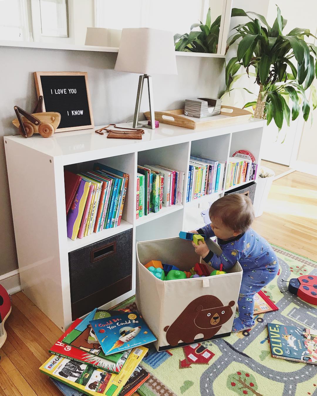 Storage shelf used for kids' toys and books. Photo by Instagram user @oliverandpenn