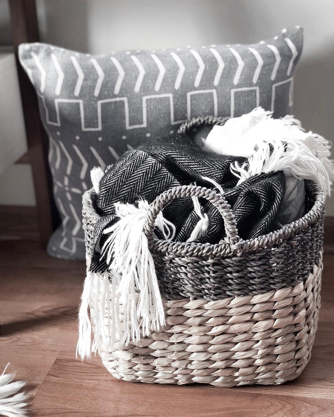 Wicker basket for blanket storage. Photo by Instagram user @isadayana