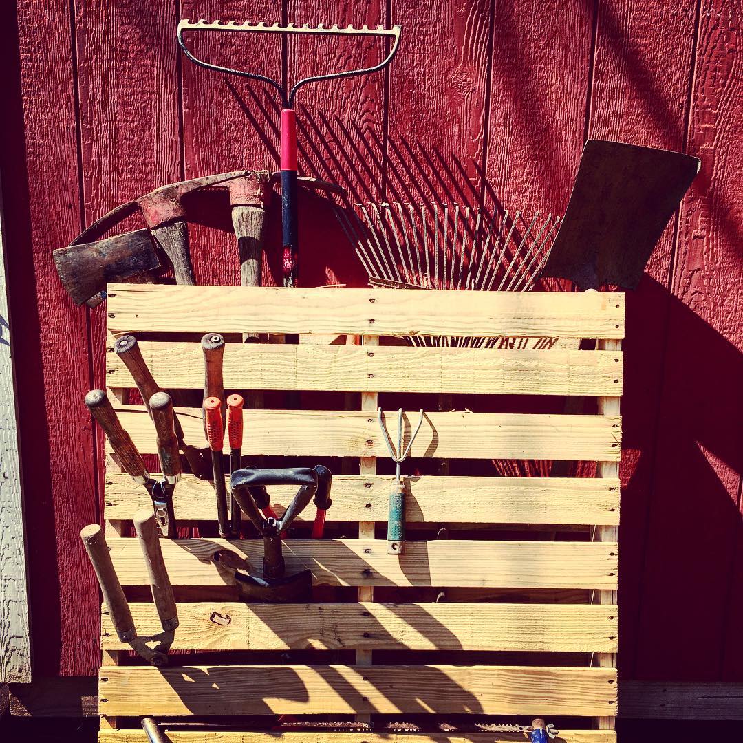 Several tools strung up on wooden pallet. @angiemcdevitt