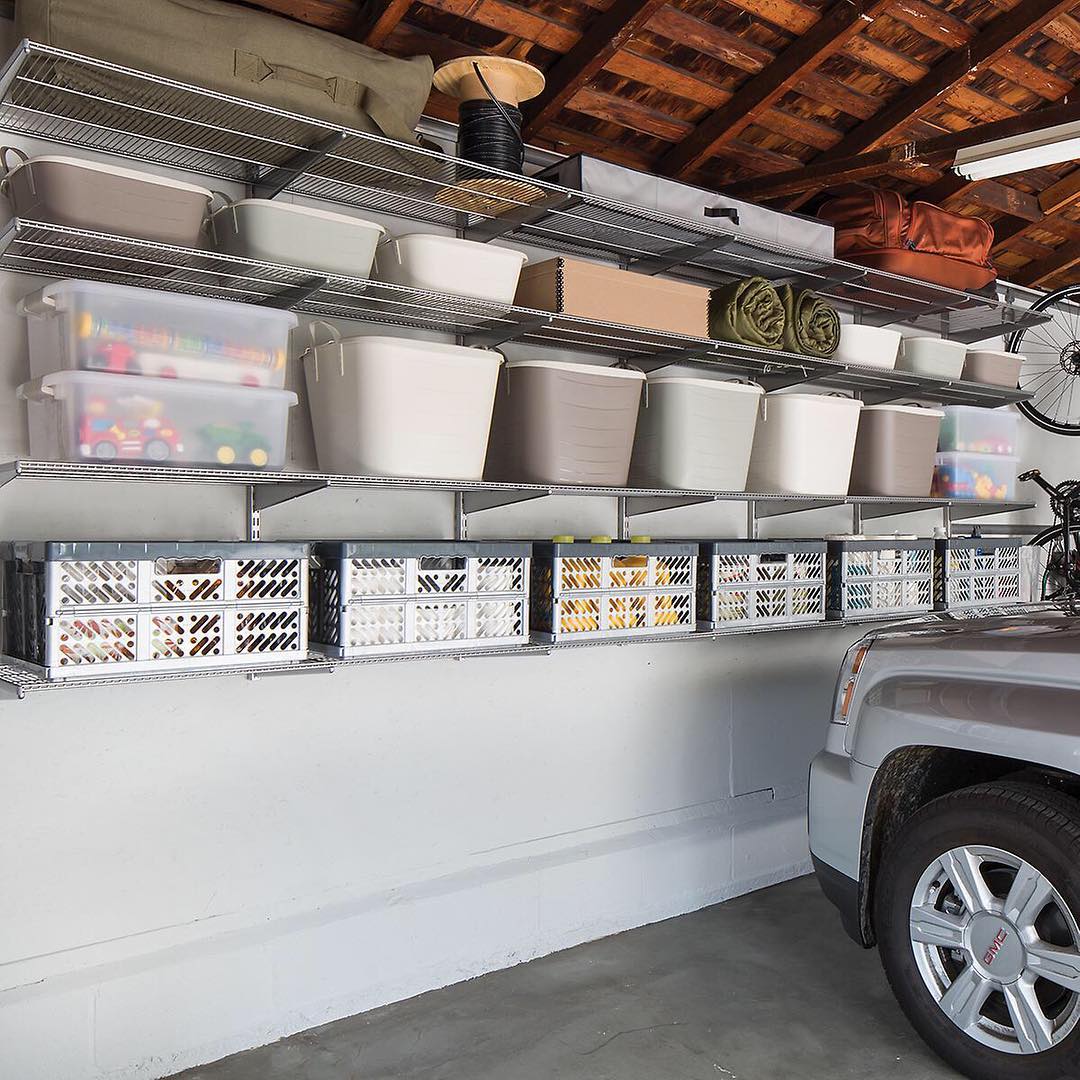 Three shelves filled with storage containers in a garage @thecontainerstore