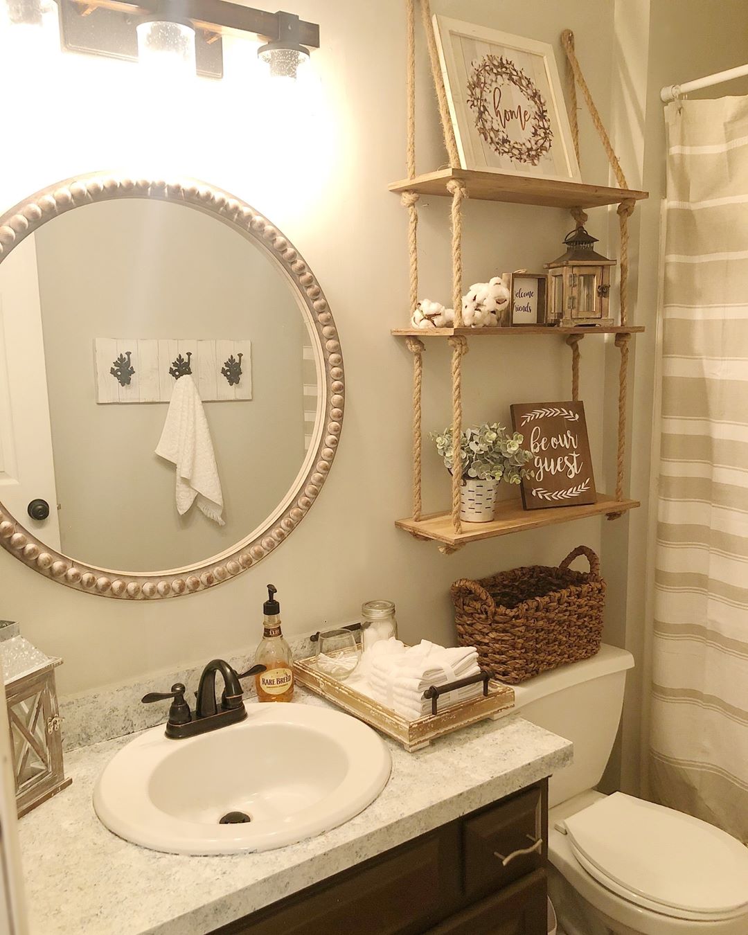 Bathroom with Hanging Shelves Above Toilet. Photo by Instagram user @interiors_by_danielle