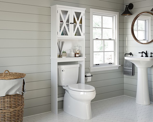 White over-the-toilet cabinet and shelf in a neutral bathroom. Photo by Instagram user @khemlanimart.