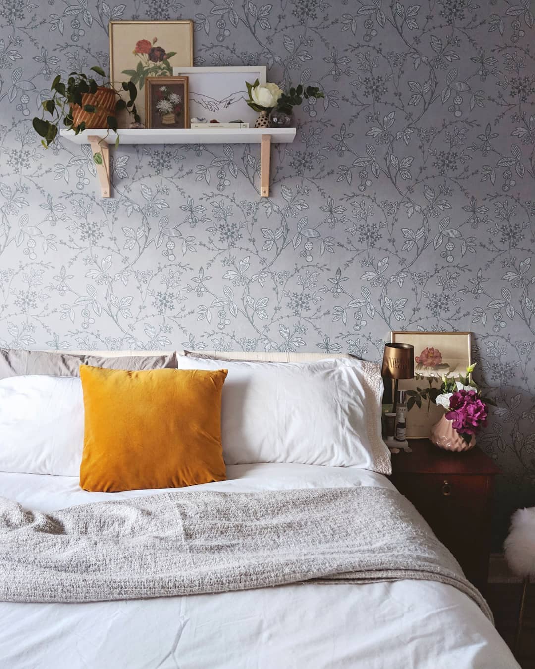 Minimalist Bedroom with Floating Shelf Containing Plants and Photos. Photo by Instagram user @thetetburyhouse