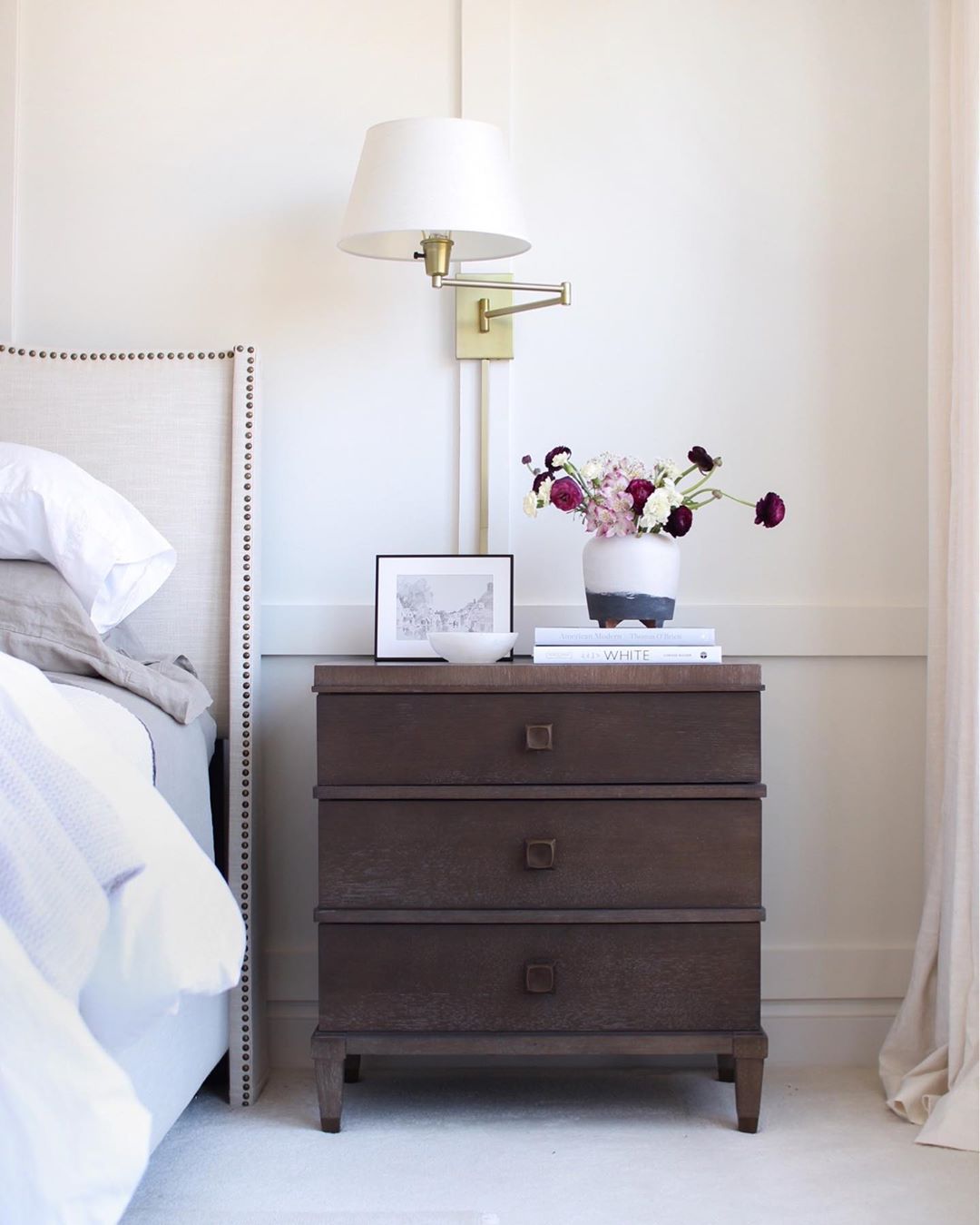 Wooden Nightstand Next to Made Bed. Photo by Instagram user @thesimplystyledhome