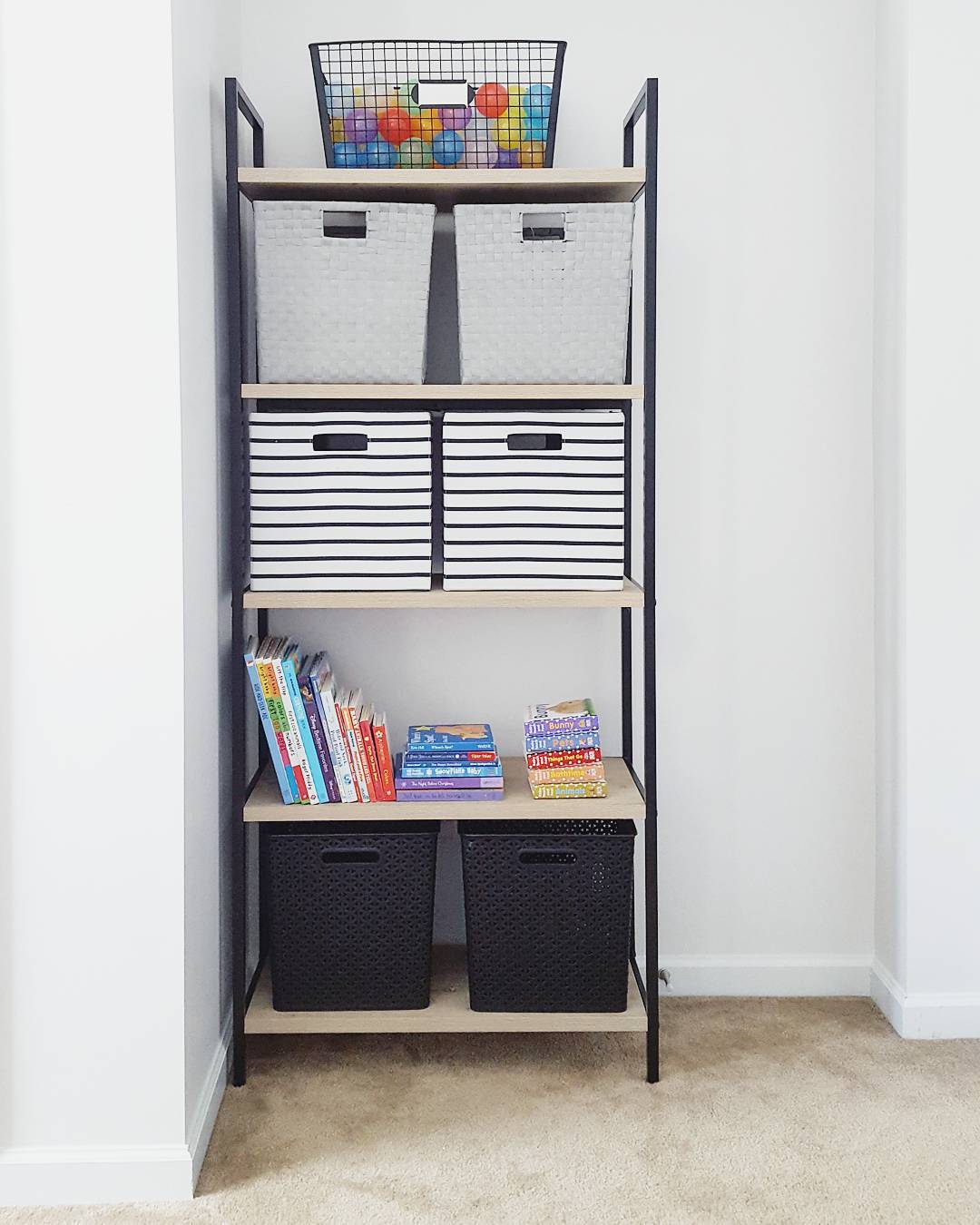 Kids Bookshelf with Bins Storing Toys and Books. Photo by Instagram user @melissasabra