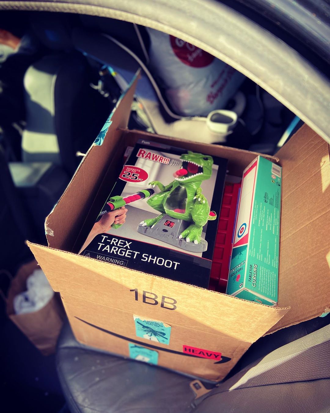 Box with Toys for Donation in Car. Photo by Instagram user @motogirly