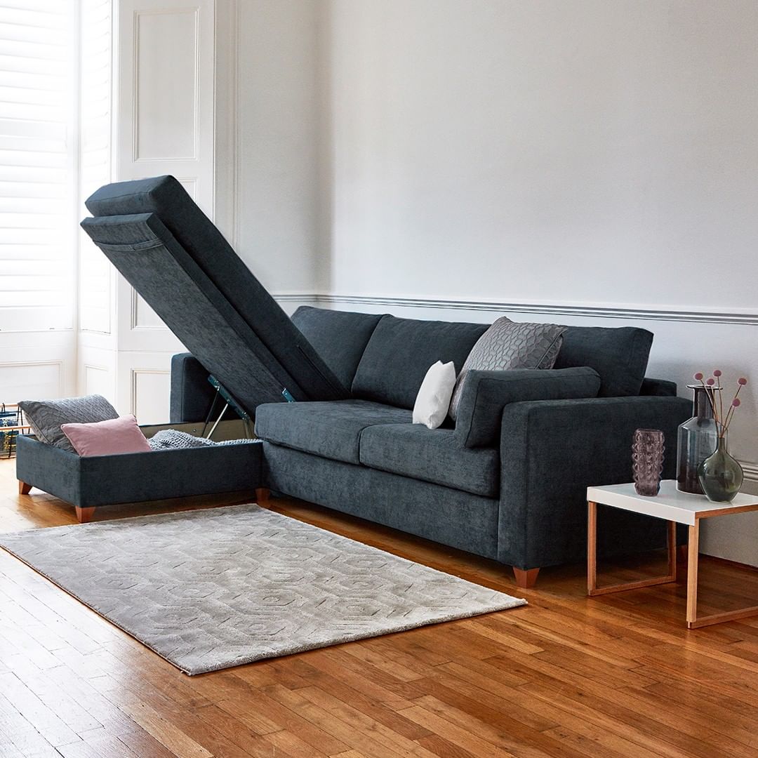 Blue couch in a minimalist living room with a storage chaise. Photo by Instagram user @willow_and_hall