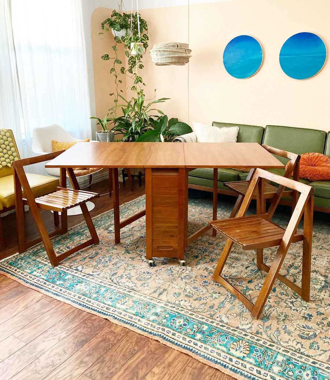 Teak folding table and chairs set in a bright living space. Photo by Instagram user @recycled.restored.