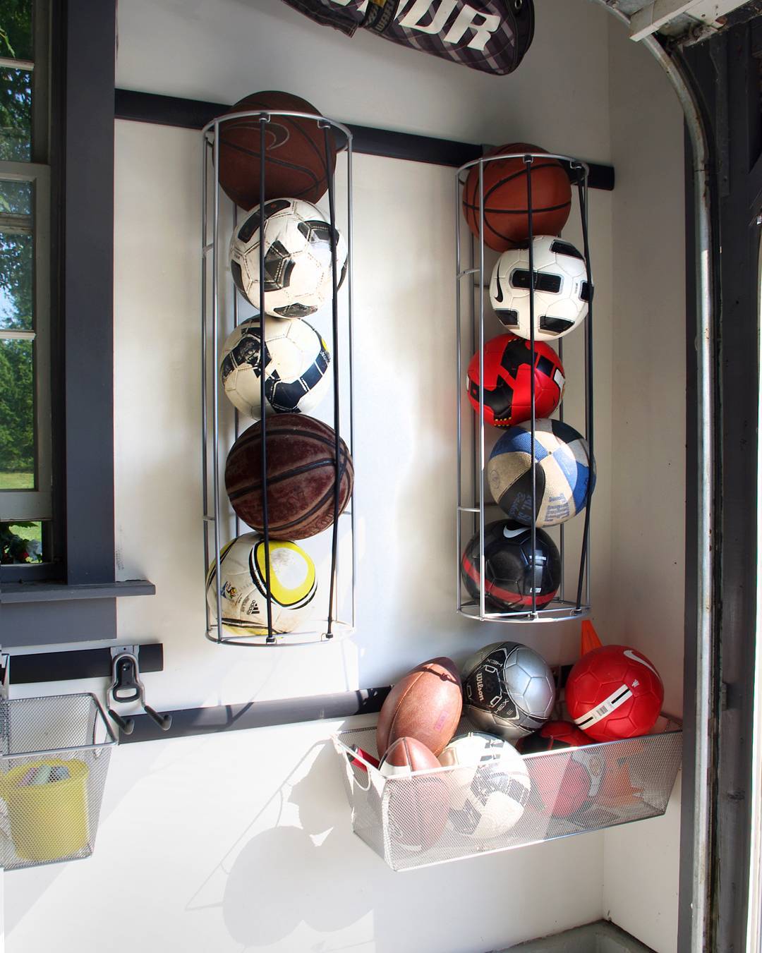 Sports Balls Stored in Vertical Nets in Garage. Photo by Instagram user @rylex_custom_cabinetry