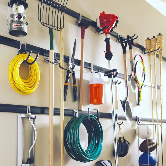 Gardening Tools and Hoses Hung on Garage Hooks. Photo by Instagram user @org_relo