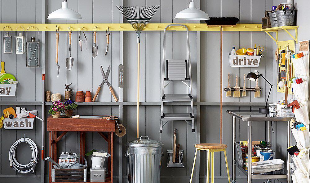 Garden Tools Hanging from Coat Racks in Garage. Photo by Instagram user @vintageestatehomes