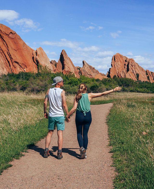 A couple holding hands, while walking on a trail at a state park. @organized_adventurer