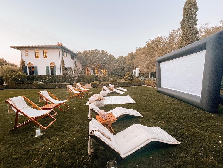 A backyard movie night with a projector and chairs. Photo by Instagram user @santabarbaratogether