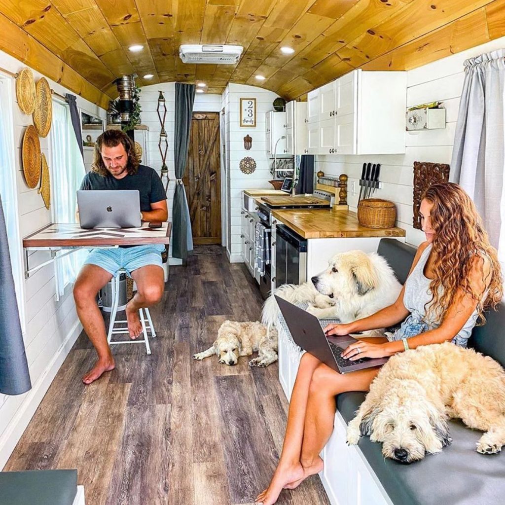 Two people working on laptops in an RV. Photo by Instagram user @_the_road_explorer_