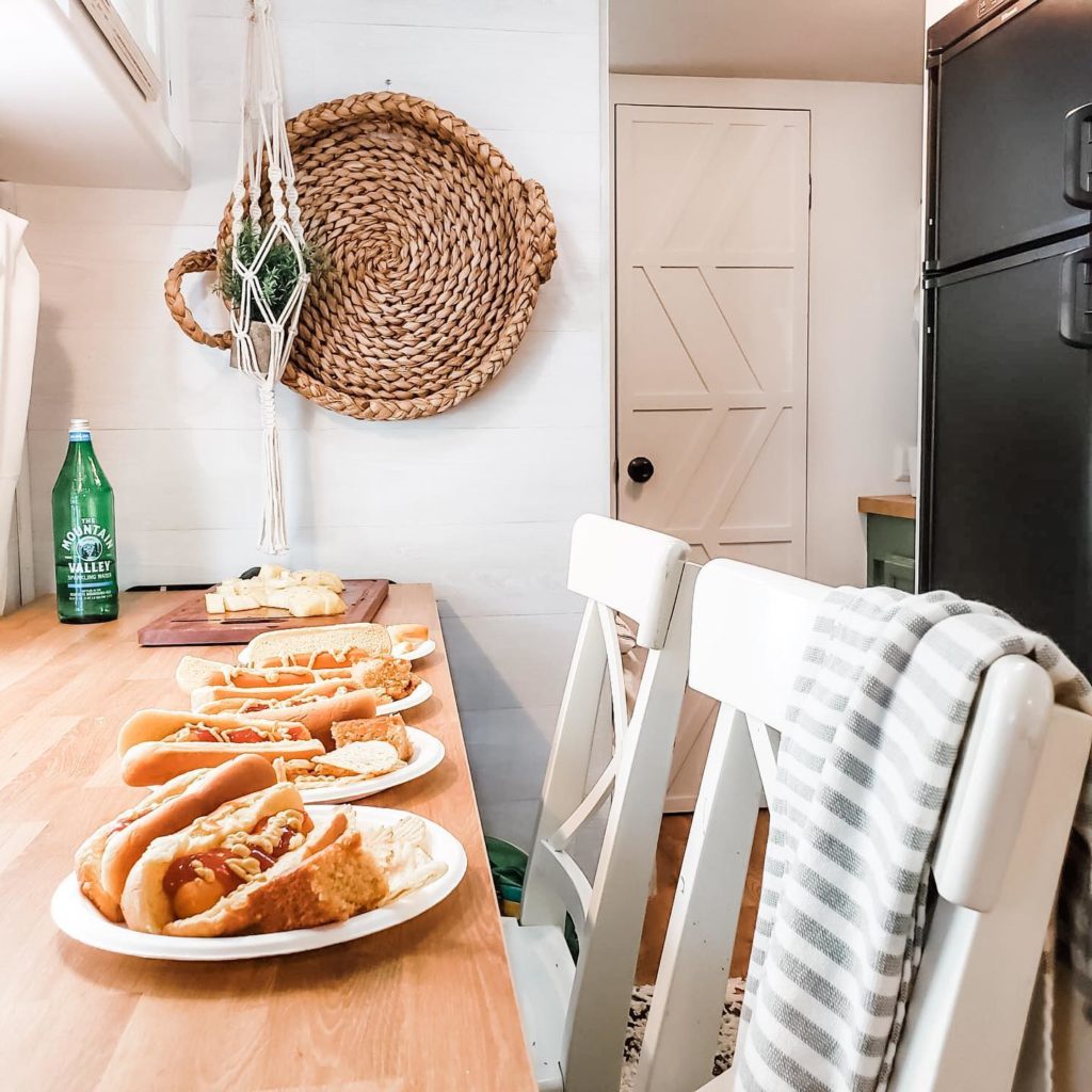 RV eating area with white chairs. Photo Credit @rv.family.reno