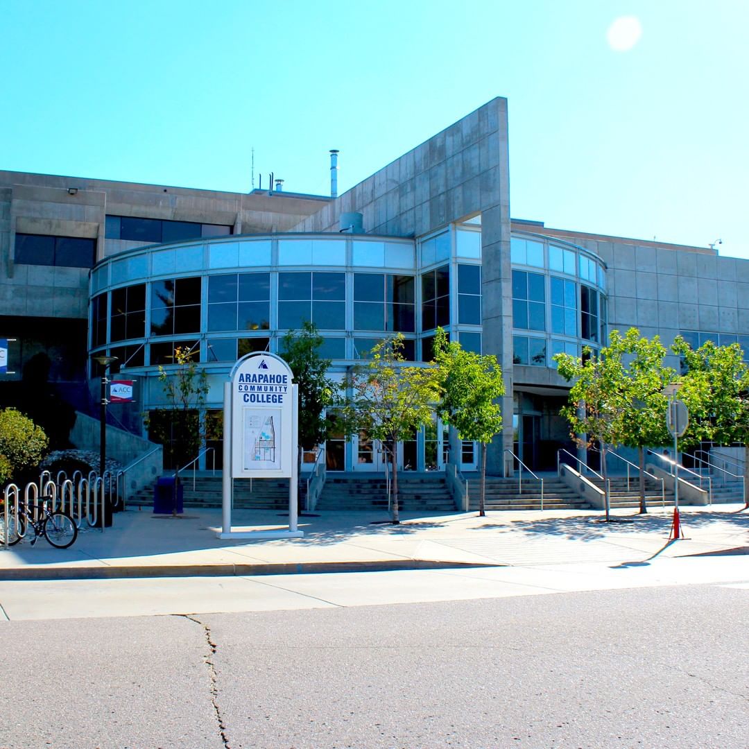 Exterior view of a Arapahoe community college building with a lot of glass windows. @arapahoe_cc