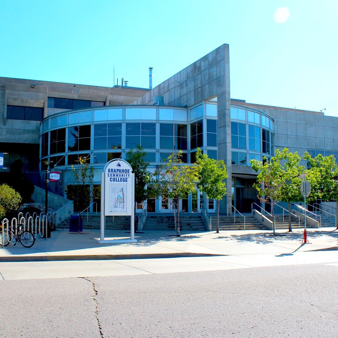 Exterior view of a Arapahoe community college building with a lot of glass windows. @arapahoe_cc