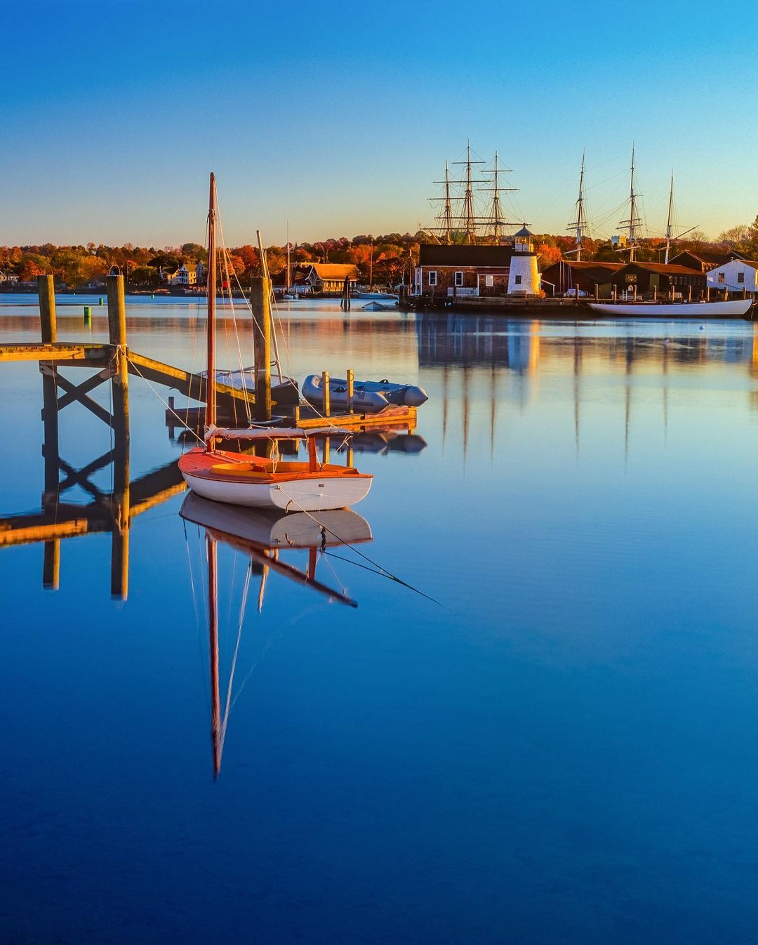 Boat Sitting on the Clear Blue Water in Mystic, CT. Photo by Instagram user @southeasternctliving