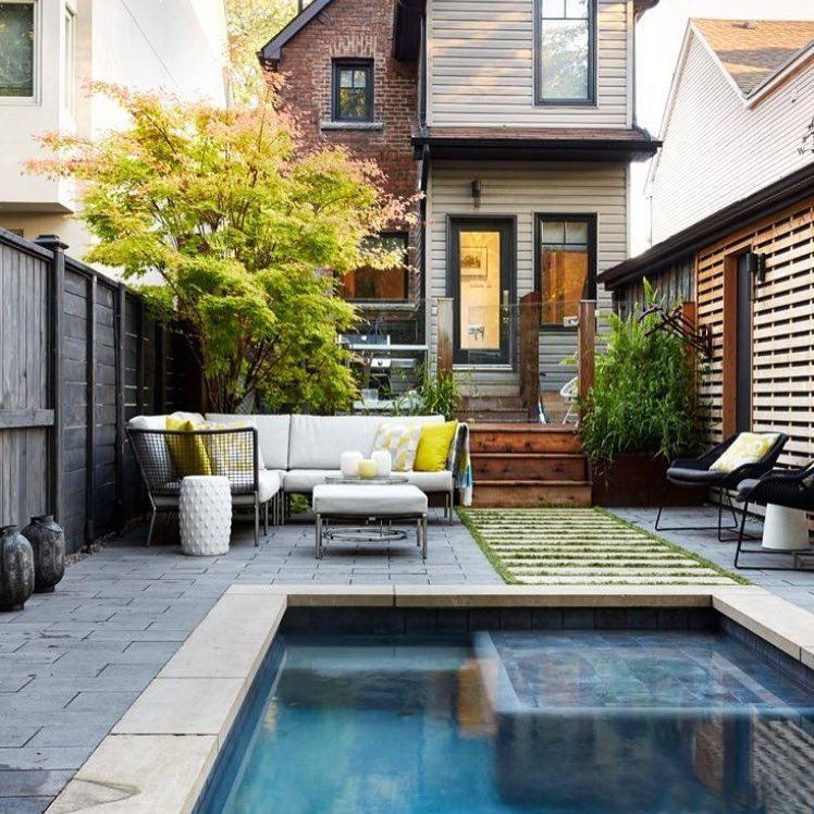 small backyard space with paved area, couch, and small pool photo by Instagram user @johnbaranellodesign