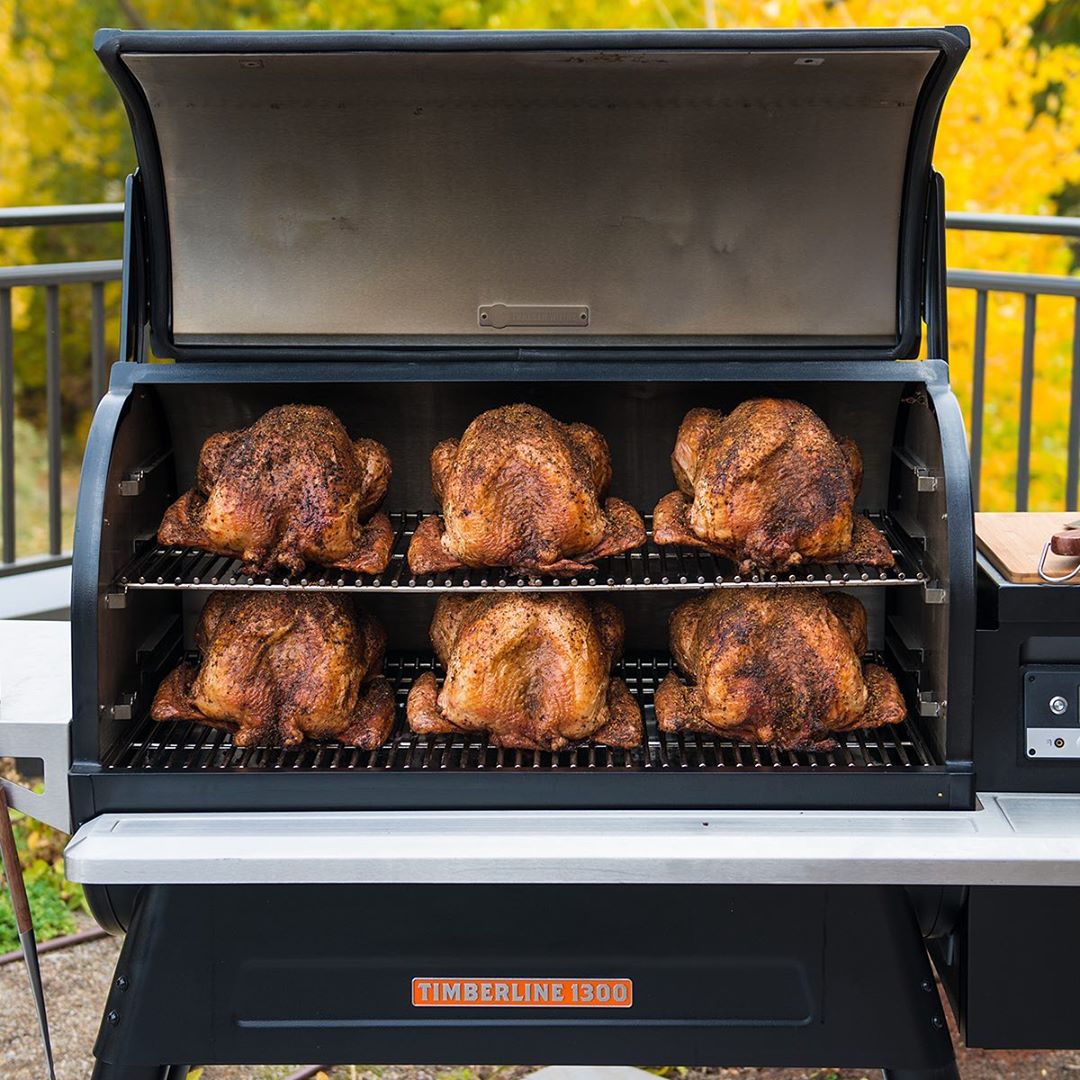 six whole chickens being smoked inside of a traeger grill photo by Instagram user @traegergrills