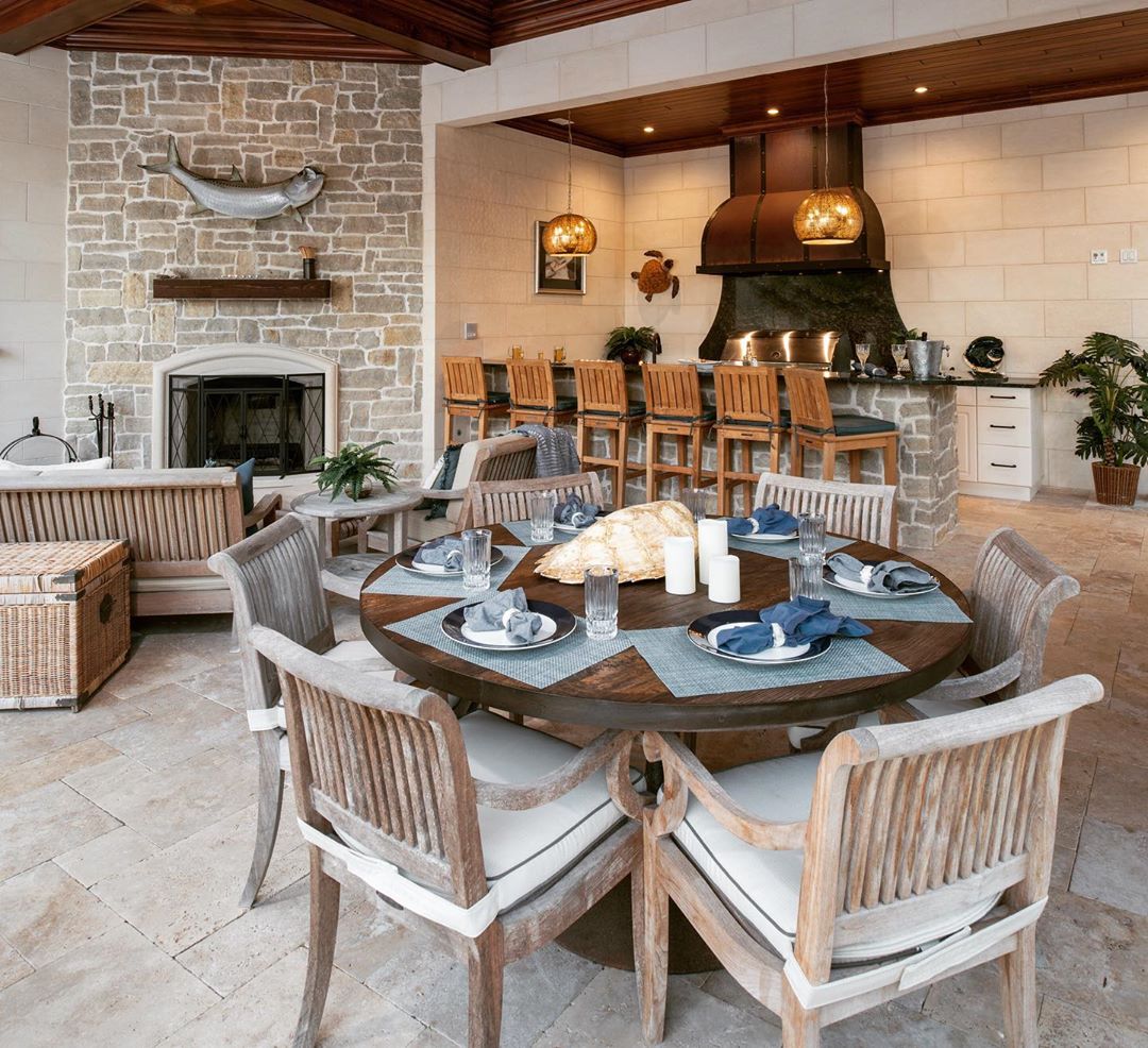 outdoor kitchen table with place settings all set photo by Instagram user @petoskeykitchens