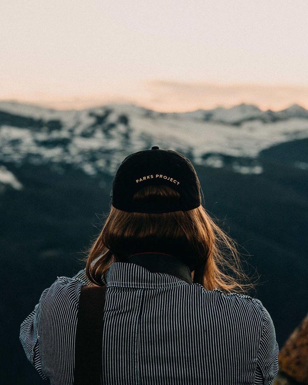 Blogger Overlooking the Mountains at Sunset in Colorado. Photo by Instagram user @tuckerneffewing