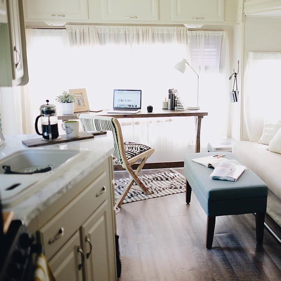 Work Station with Desk and Laptop Set Up Inside an RV. Photo by Instagram user @tinyflip