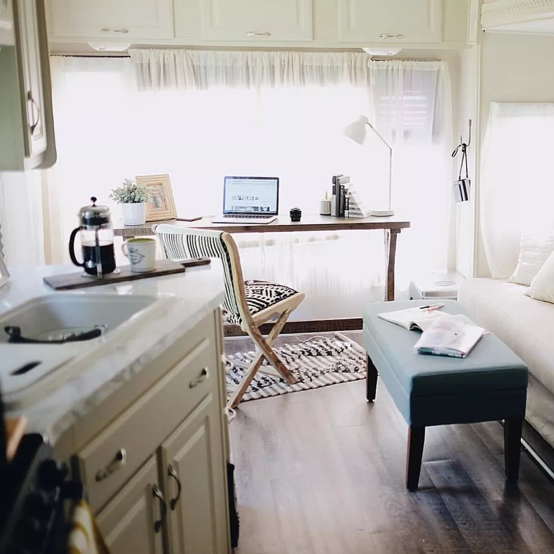 Work Station with Desk and Laptop Set Up Inside an RV. Photo by Instagram user @tinyflip