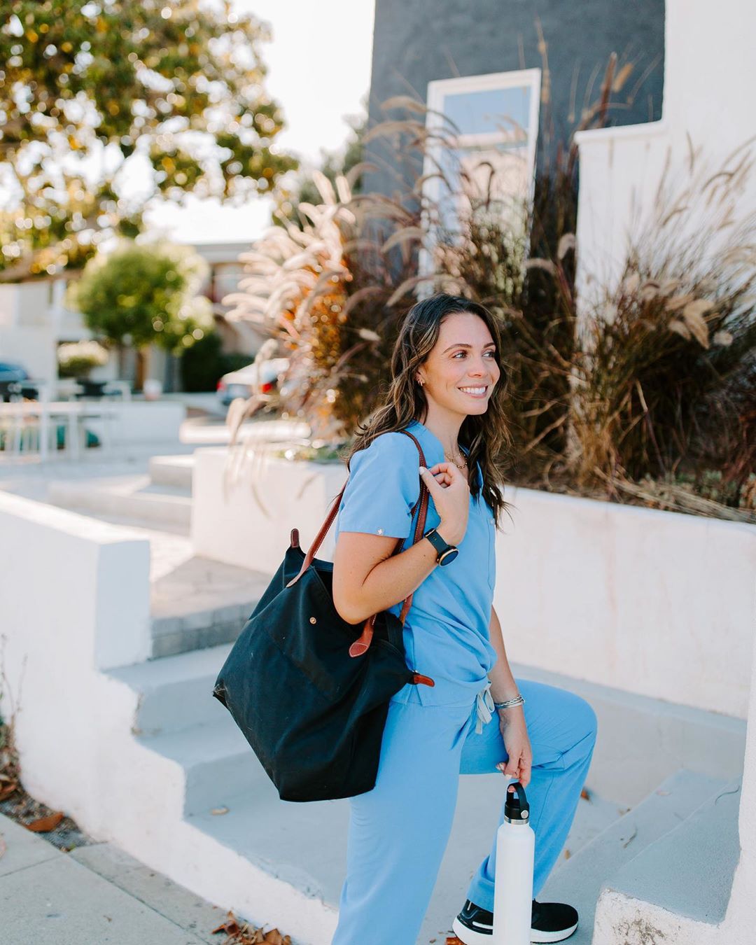 Nurse with a Traveling Bag Approaching Hospital Steps. Photo by Instagram user @becksliveshealthy