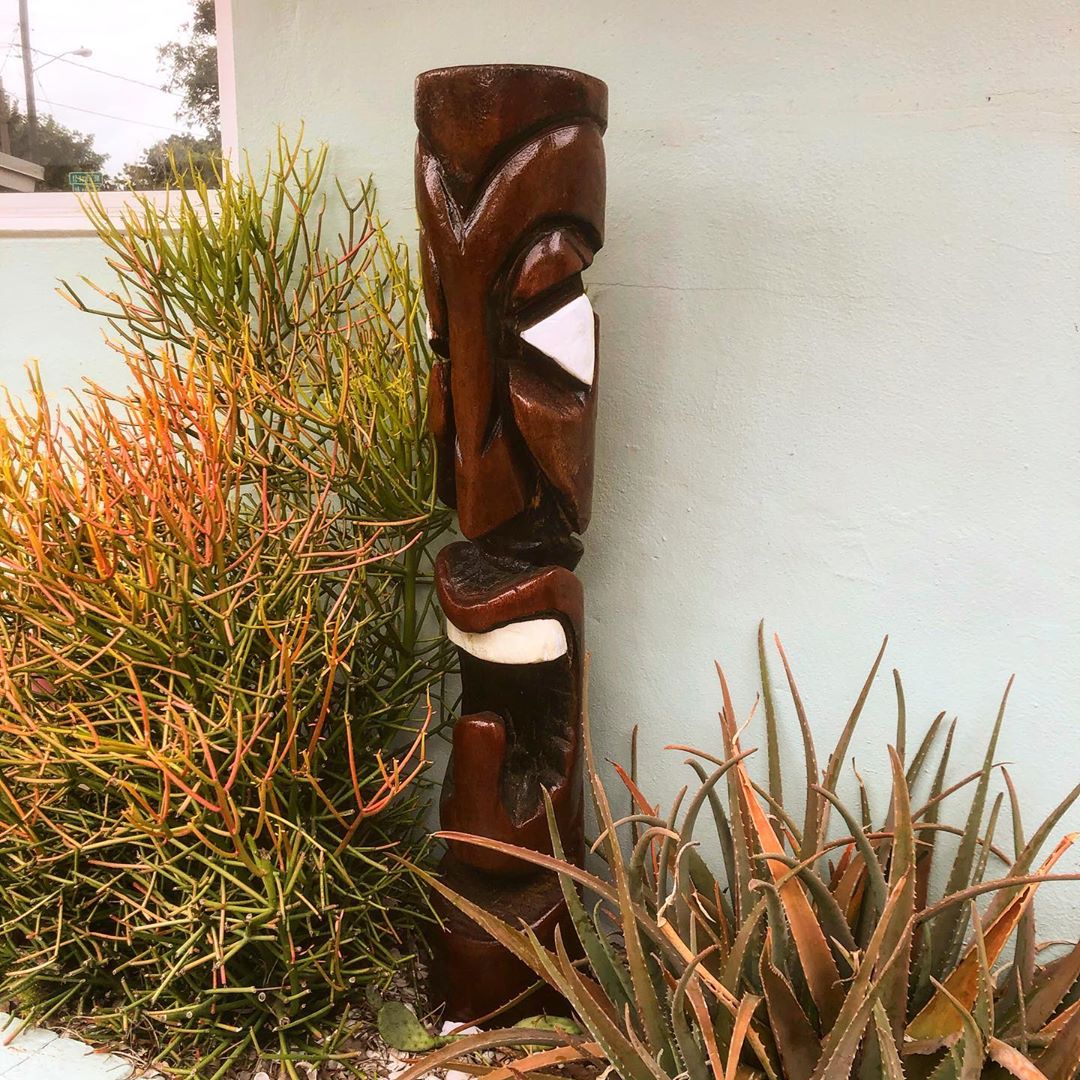 tiki sculpture place in a planting bed in the backyard photo by Instagram user @5_oh_tiki