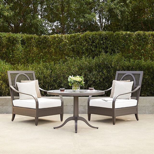iron outdoor furniture with white cushions and table photo by Instagram user @teresajackson_jec