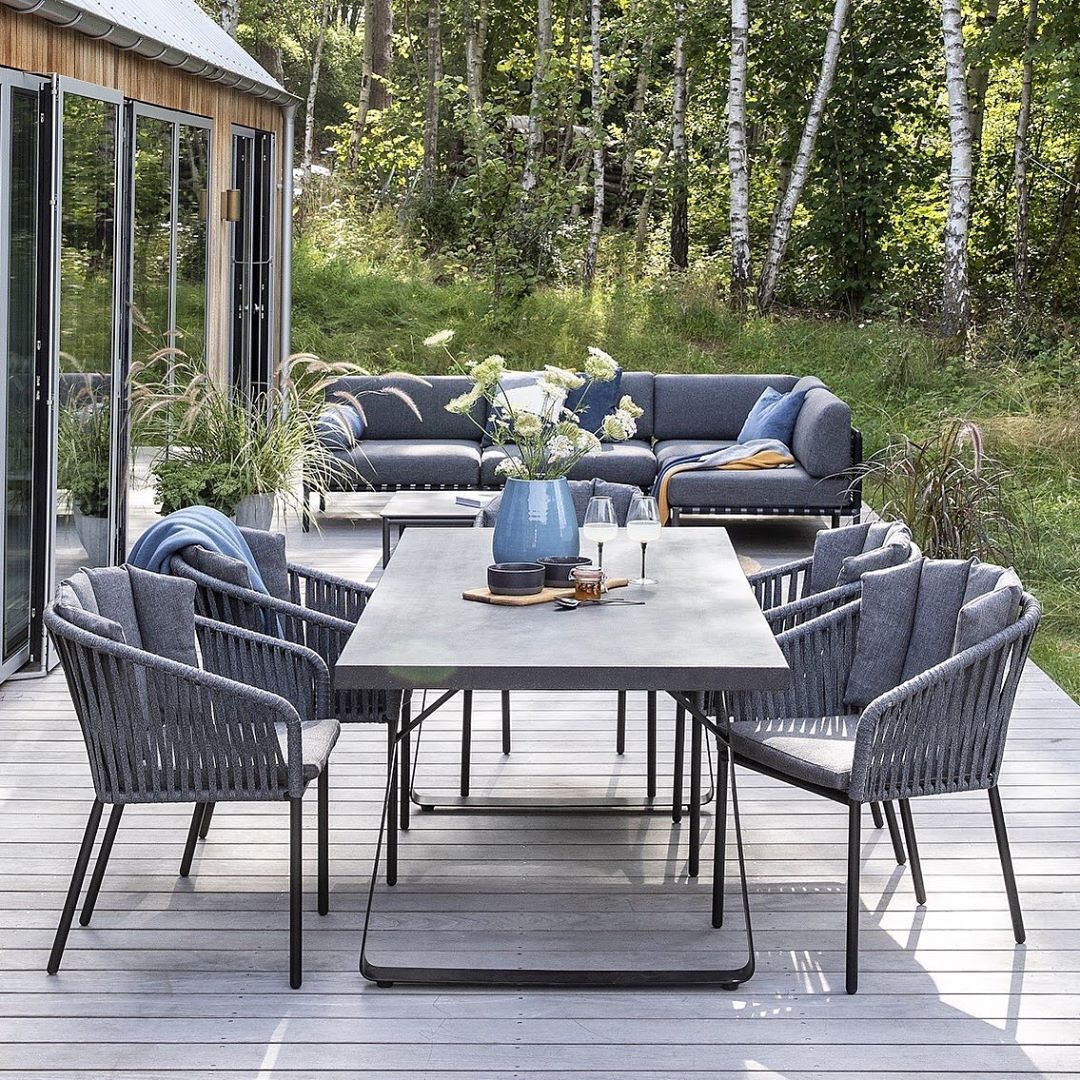 table and chairs and outdoor couch spaced on the deck photo by Instagram user @iddesign_hun