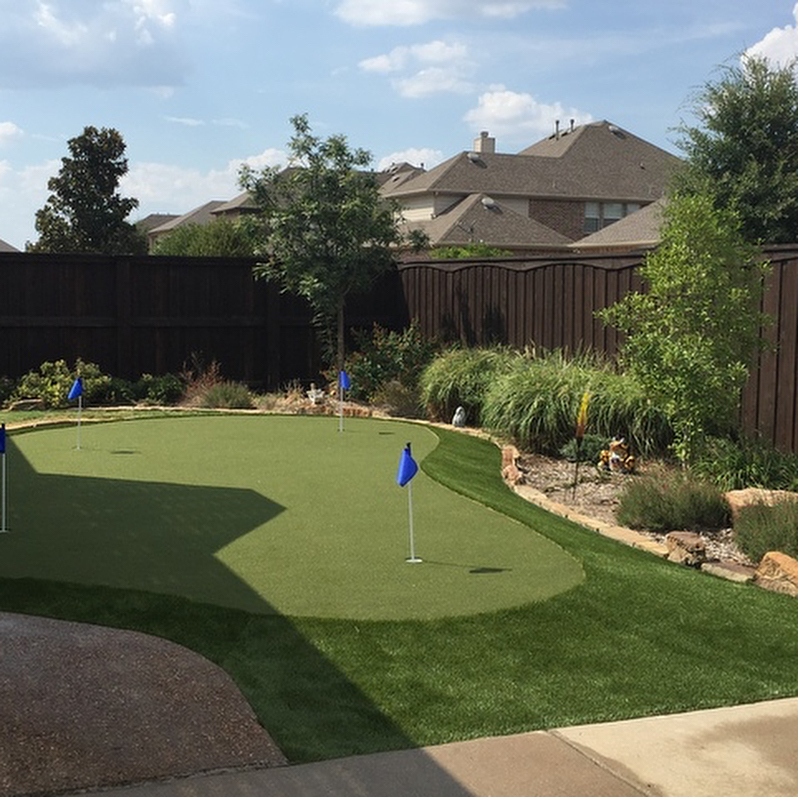 backyard putting green with three holes using fake turf photo by Instagram user @scott_dfw_turf