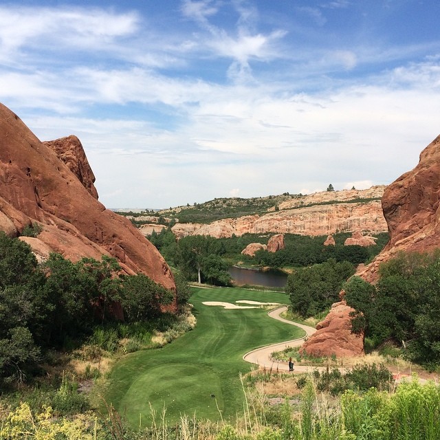 Looking down a golf course green placed between two red rock mountains Photo by Instagram user @va_av8r