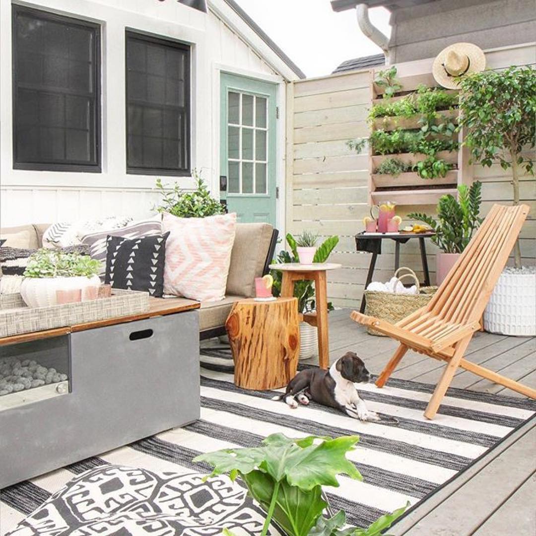 hanging plant wall set up next to outdoor living space photo by Instagram user @solehabitat