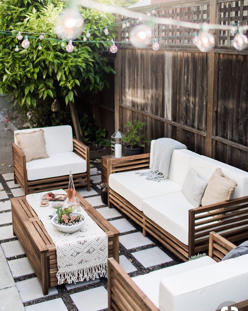 small patio with string lights and outdoor seating around a table photo by Instagram user @questfk