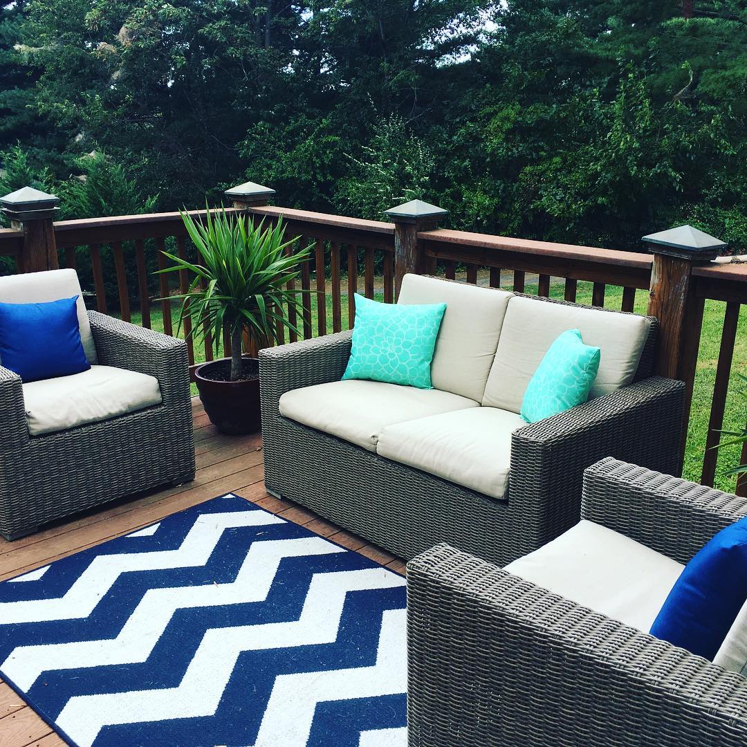 outdoor love seat and chairs sitting on an open deck photo by Instagram user @barb__herndon
