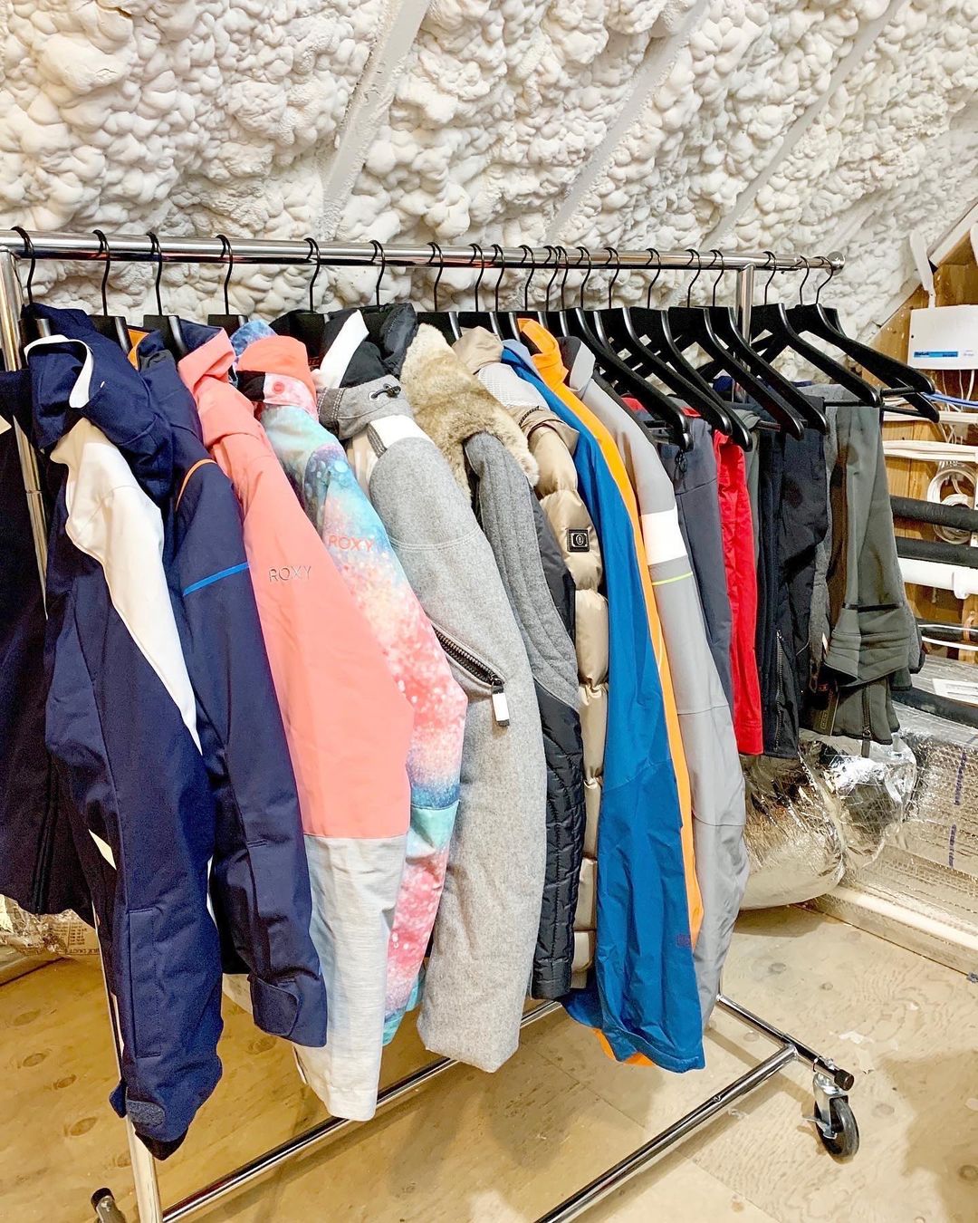 Coats Hung on a Clothing Rack in an Attic. Photo by Instagram user @getitdonebystephanie