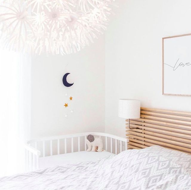 Small Bedroom with a Open Front Bassinet Next to the Bed. Photo by Instagram user @babybayusa