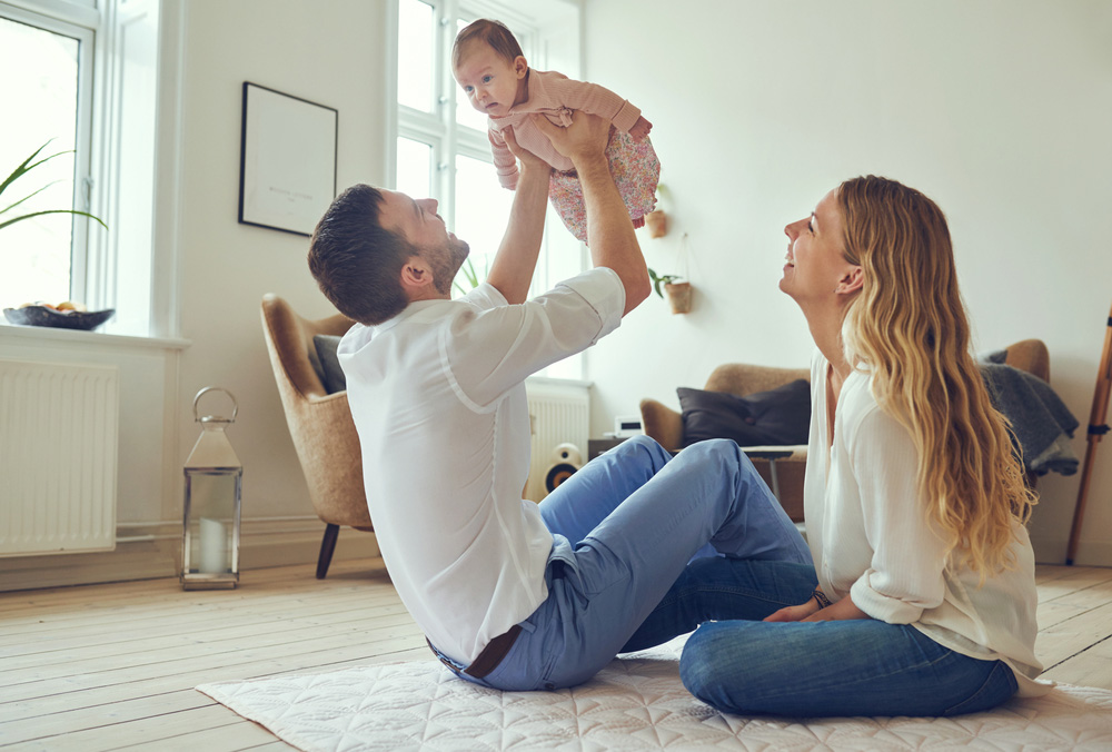 Young parents with baby in small apartment