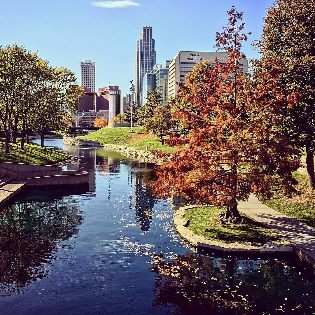 Gene Leahy Mall in fall with water and Omaha skyline. Photo by Instagram user @visitomaha.