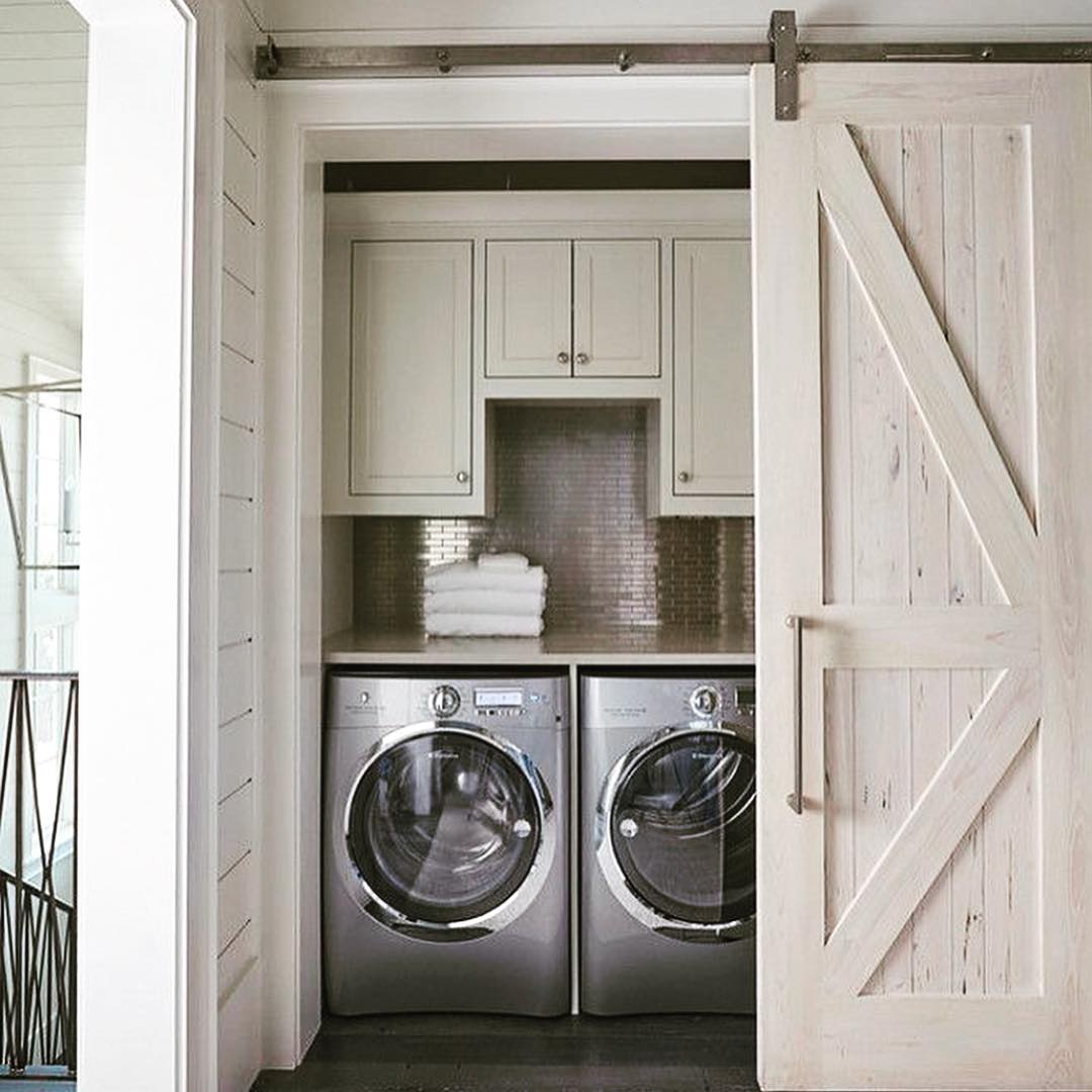 Stylish Wood Sliding Door to Laundry Room. Photo by Instagram user @glitterlaine