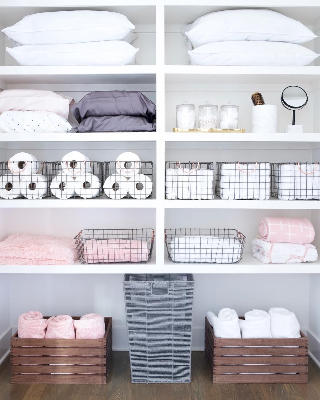 Towels and Laundry Bin Stored on Floor of Linen Closet. Photo by Instagram user @thehomeedit