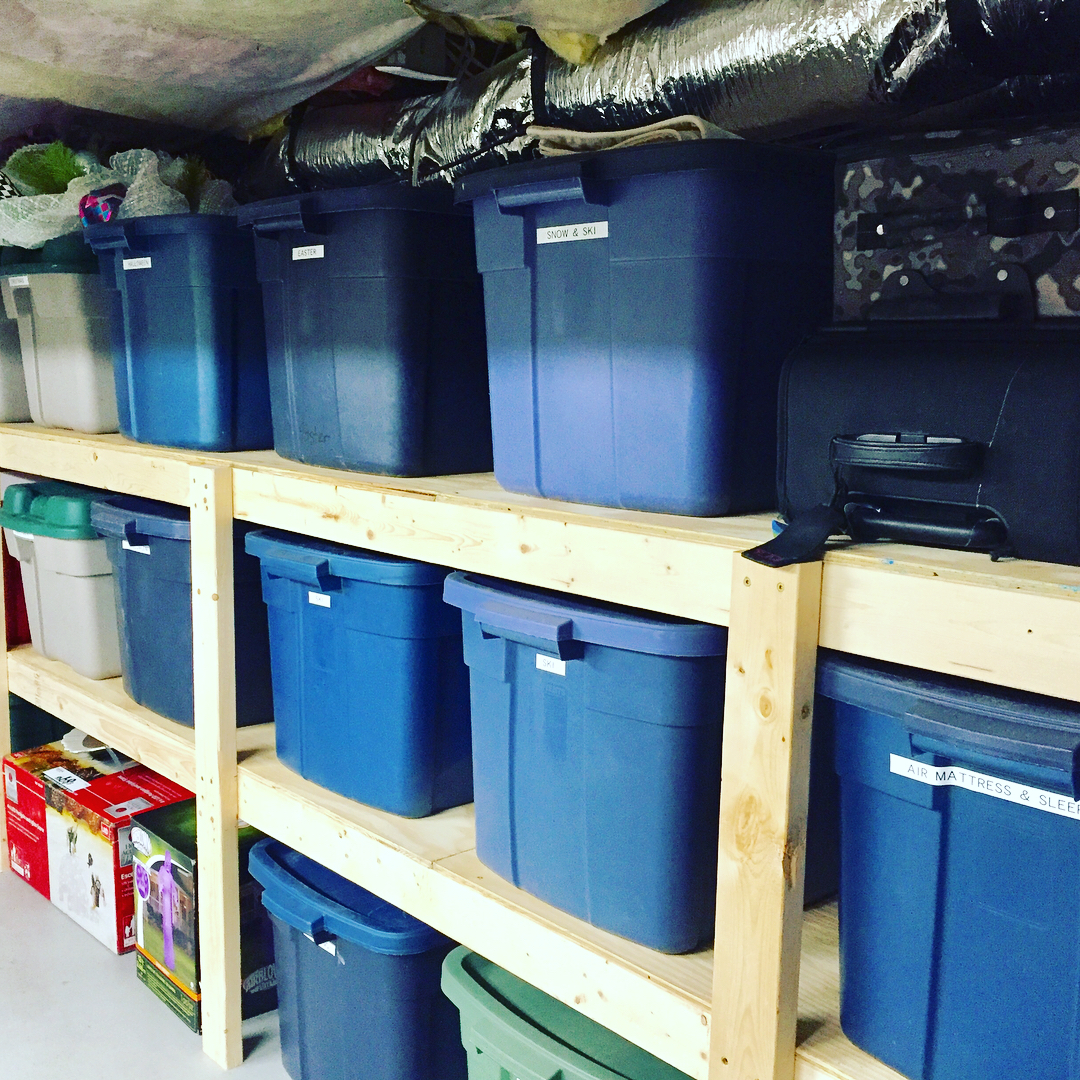 Blue storage tubs in storage room. Photo by Instagram user @organizedforyou