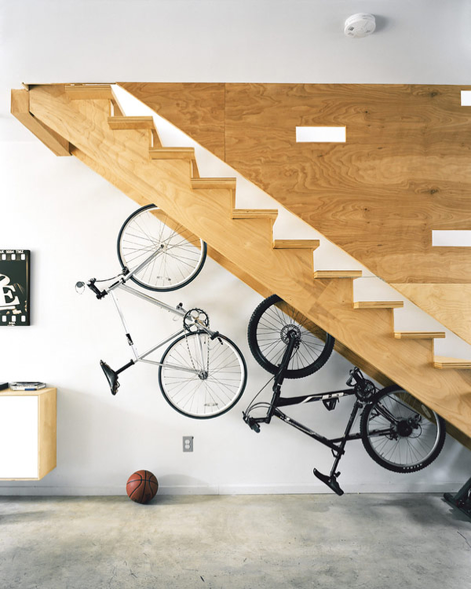 Bikes hung up beneath stairs to save space.