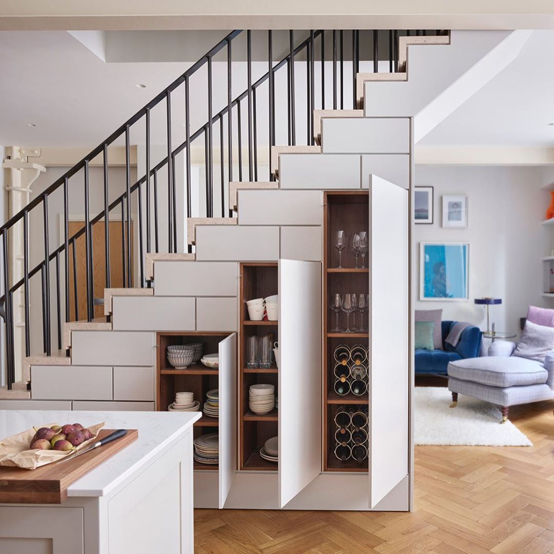 Additional cabinet storage for kitchen dishes under the stairs.