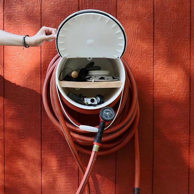 Old Five Gallon Bucket Converted Into a Hose Holder. Photo by Instagram user @branchingtogether